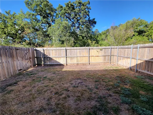 a view of outdoor space with deck and wooden fence