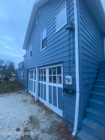 a view of a house with backyard and wooden fence
