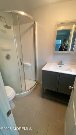 a bathroom with a sink a toilet and mirror