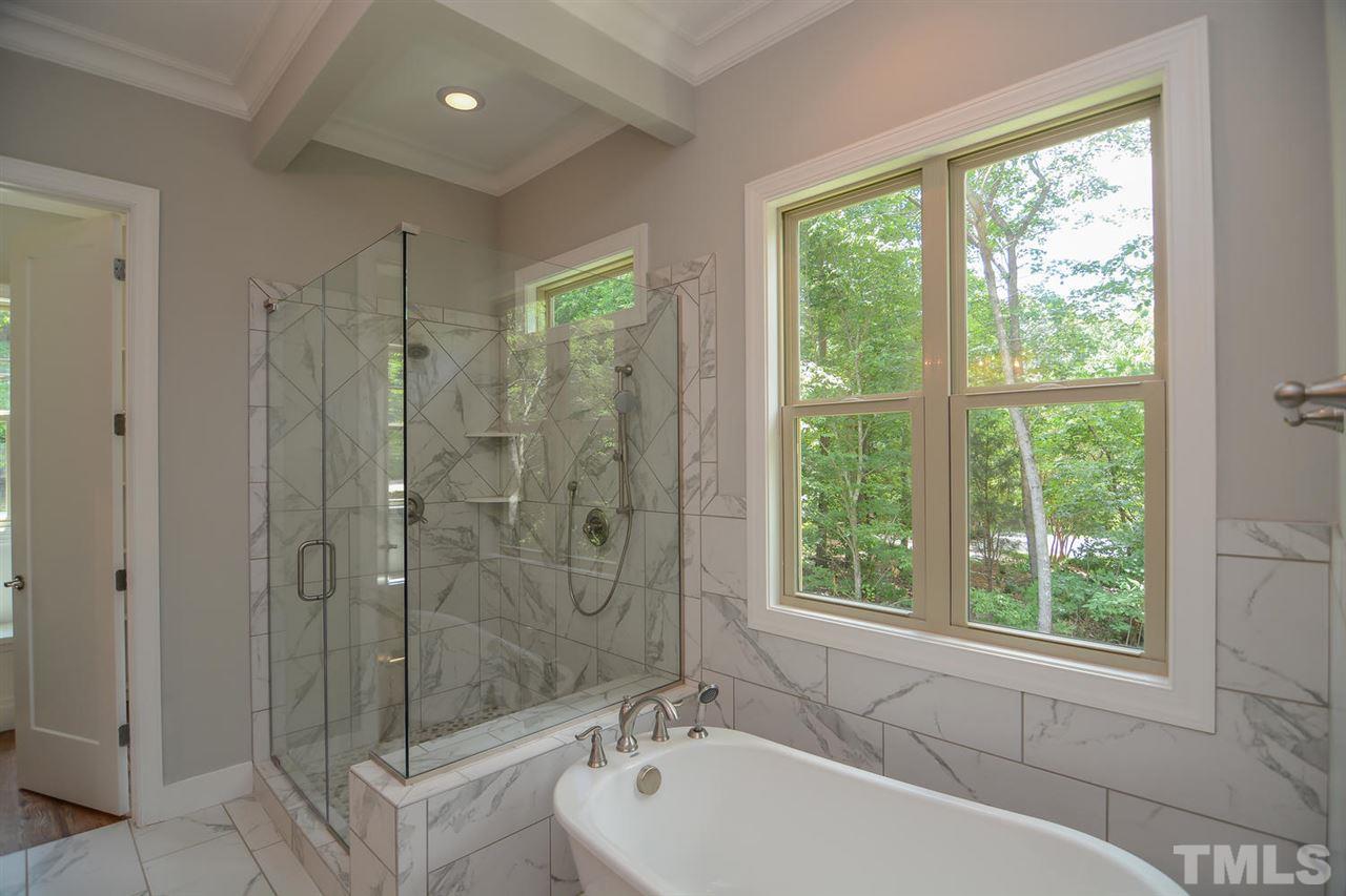 11500 Old Creedmoor Road Raleigh, NC 27613 - Photo 8 of 25 a bathroom with a bathtub a shower and a sink