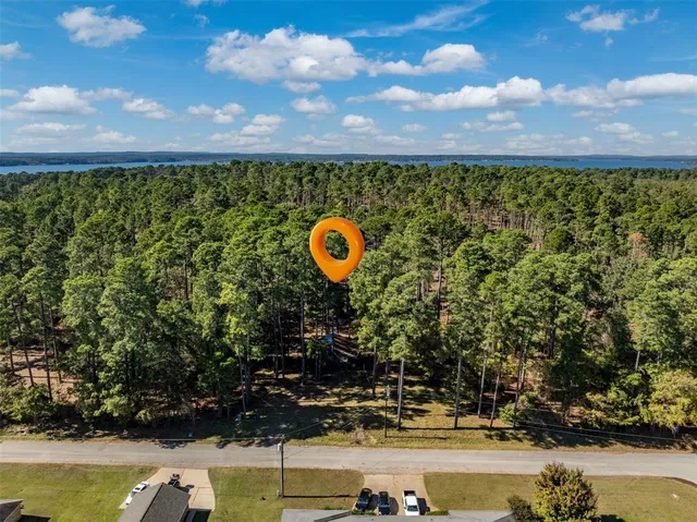 a view of a swimming pool with a patio and a yard