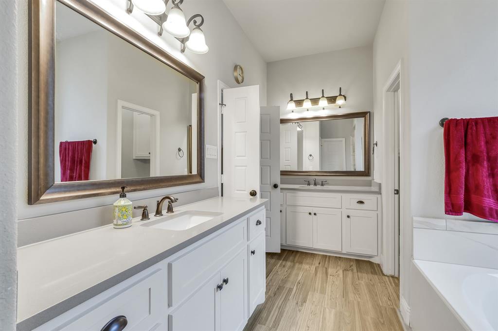 1306 Elizabeth Street Anna, TX 75409 - Photo 14 of 36 a spacious bathroom with a double vanity sink and a mirror