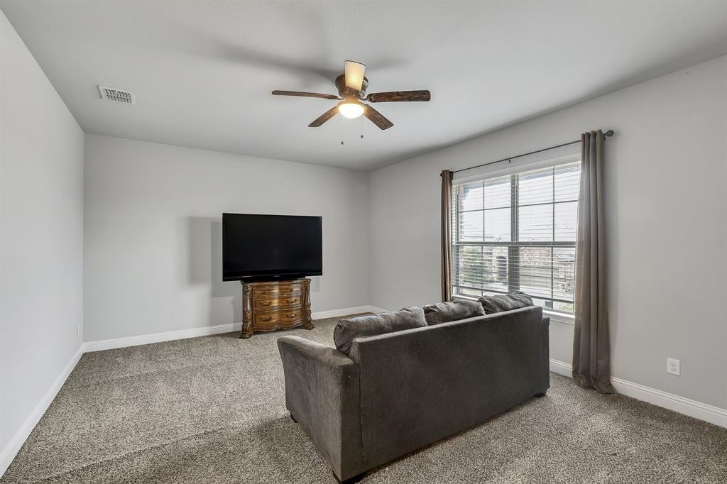 1306 Elizabeth Street Anna, TX 75409 - Photo 16 of 36 a living room with furniture and a flat screen tv