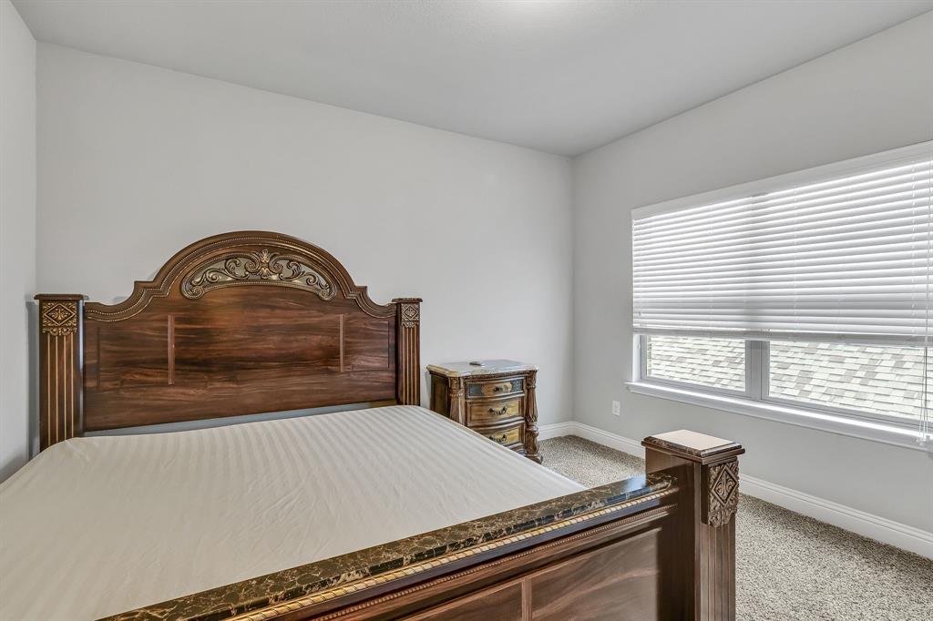 1306 Elizabeth Street Anna, TX 75409 - Photo 18 of 36 a bed sitting in a bedroom next to a window