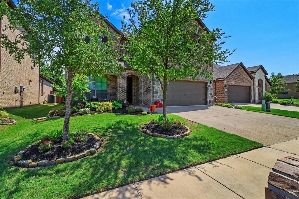 1306 Elizabeth Street Anna, TX 75409 - Photo 2 of 36 a front view of a house with a garden and trees
