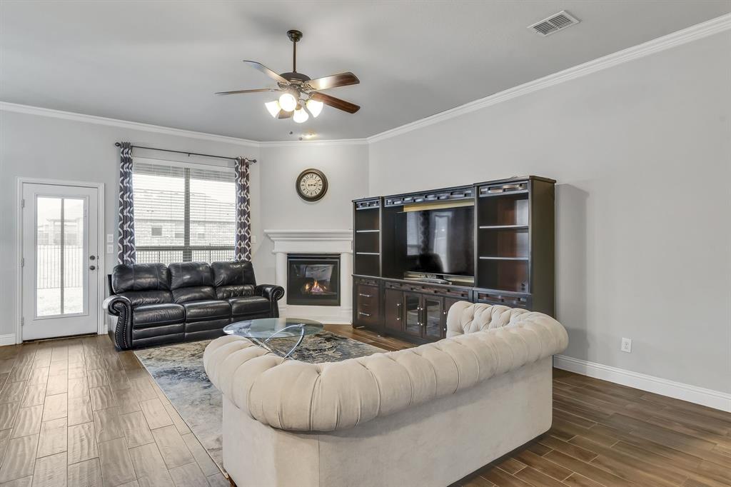 1306 Elizabeth Street Anna, TX 75409 - Photo 21 of 36 a living room with furniture and a fireplace