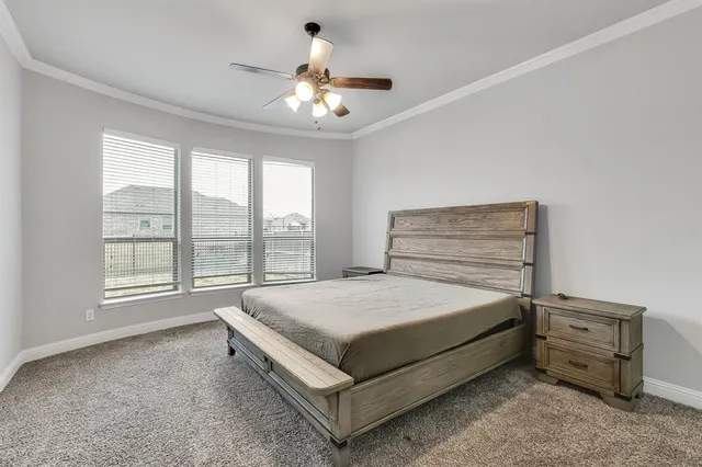 a spacious bedroom with a bed and window
