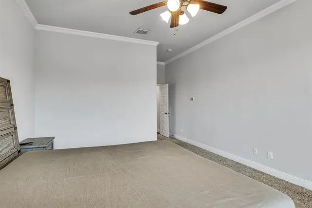an empty room with a ceiling fan and a window