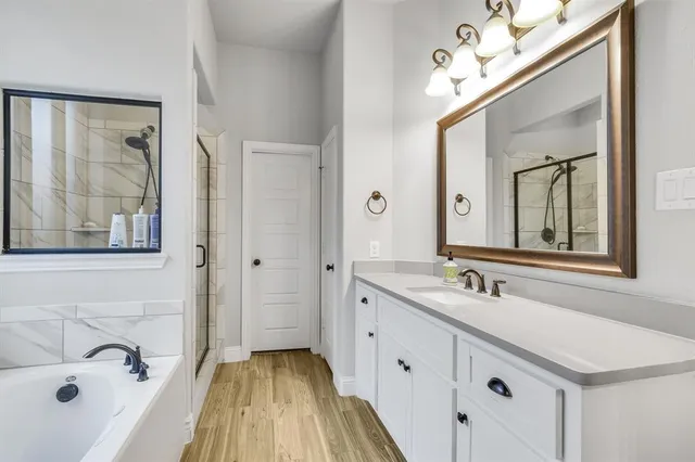 a bathroom with a double vanity sink mirror and