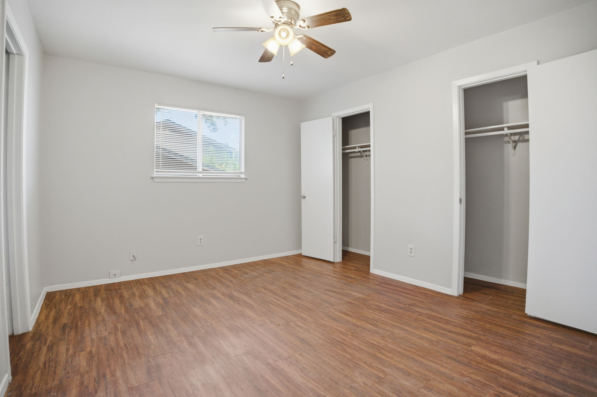 5204 Nuckols Crossing Road, Unit B Austin, TX 78744 - Photo 14 of 16 wooden floor in an empty room with a window