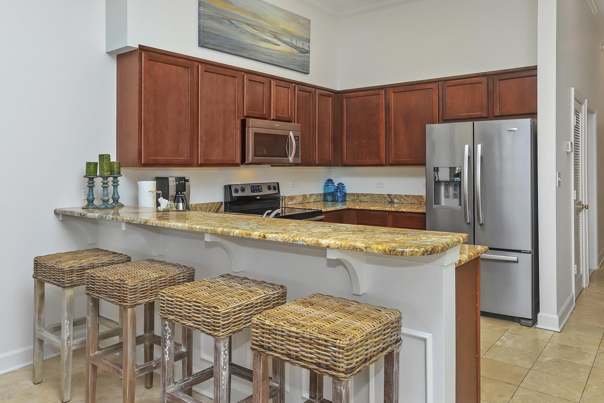 10343 East County 30-a Hwy Inlet Beach, Unit 305 Inlet Beach, FL 32461 - Photo 11 of 19 a kitchen with stainless steel appliances granite countertop a sink refrigerator and microwave