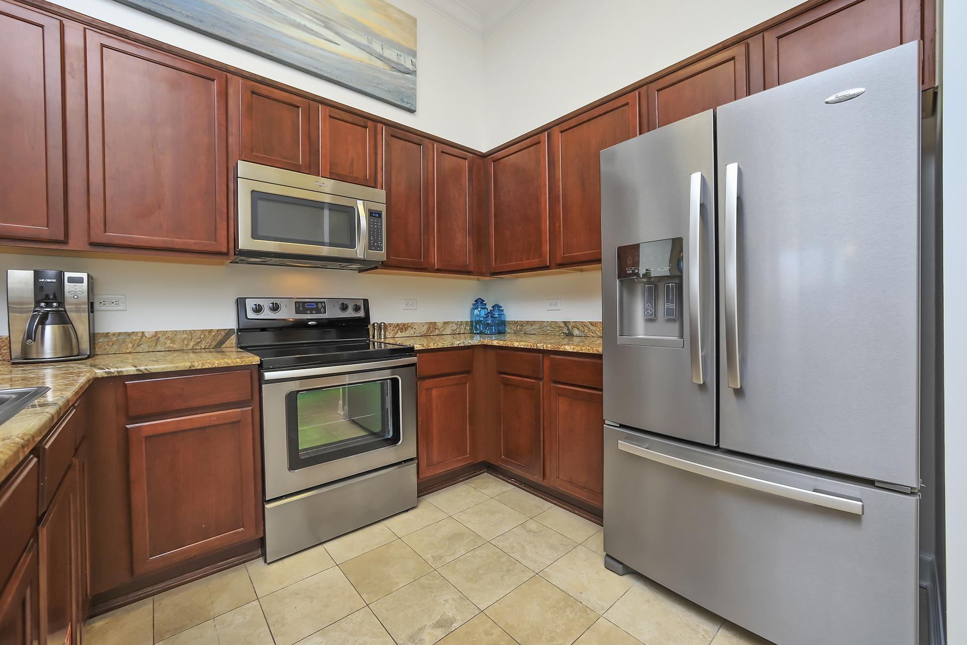 10343 East County 30-a Hwy Inlet Beach, Unit 305 Inlet Beach, FL 32461 - Photo 12 of 19 a kitchen with stainless steel appliances granite countertop a refrigerator stove top oven and sink