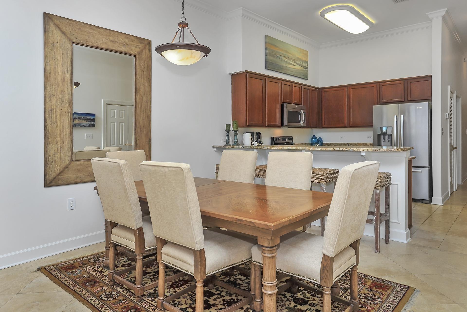 10343 East County 30-a Hwy Inlet Beach, Unit 305 Inlet Beach, FL 32461 - Photo 5 of 19 a kitchen with a dining table chairs and refrigerator