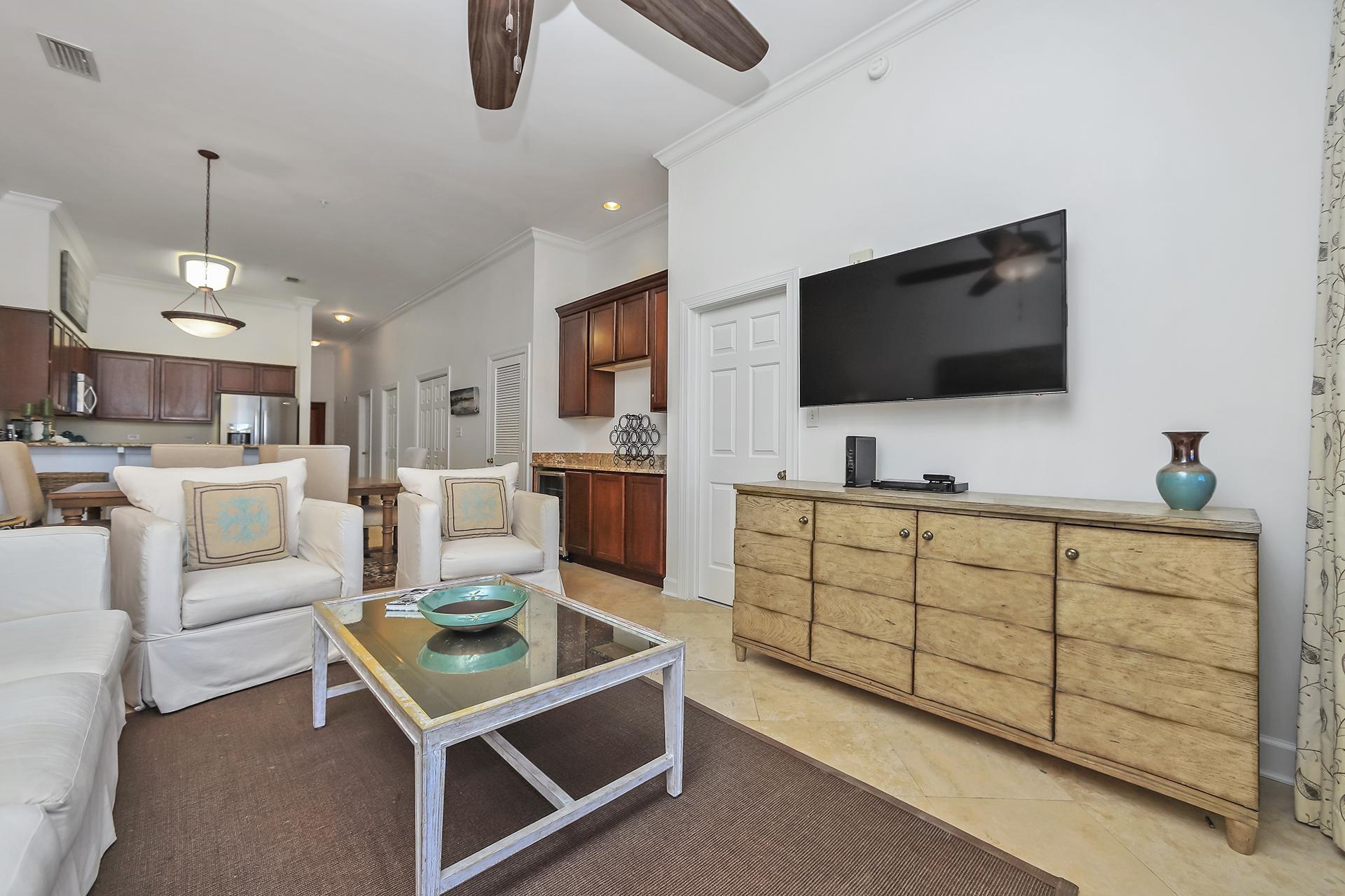 10343 East County 30-a Hwy Inlet Beach, Unit 305 Inlet Beach, FL 32461 - Photo 7 of 19 a living room with furniture a flat screen tv and kitchen view