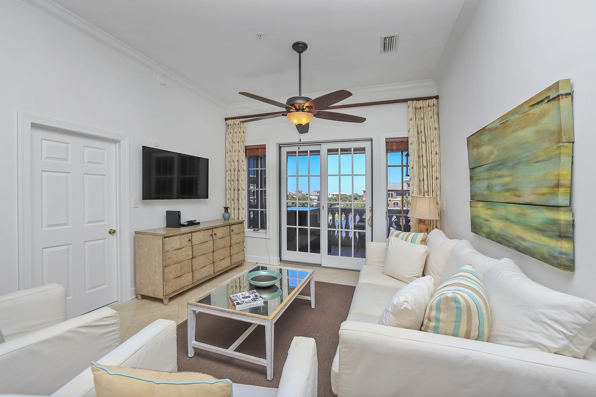 10343 East County 30-a Hwy Inlet Beach, Unit 305 Inlet Beach, FL 32461 - Photo 8 of 19 a living room with furniture a flat screen tv and a floor to ceiling window