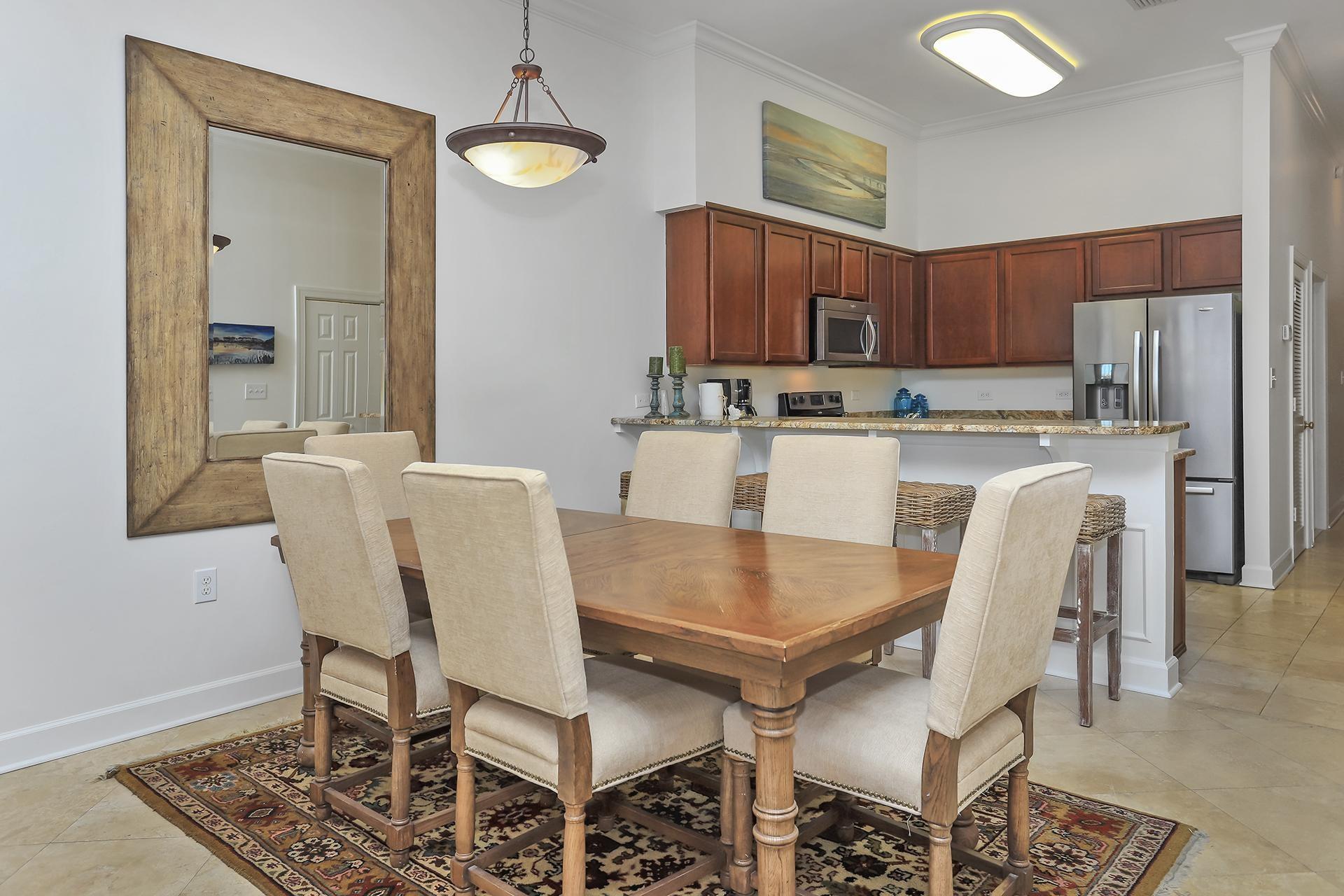 10343 East County 30-a Hwy Inlet Beach, Unit 305 Inlet Beach, FL 32461 - Photo 10 of 19 a kitchen with a dining table chairs and refrigerator