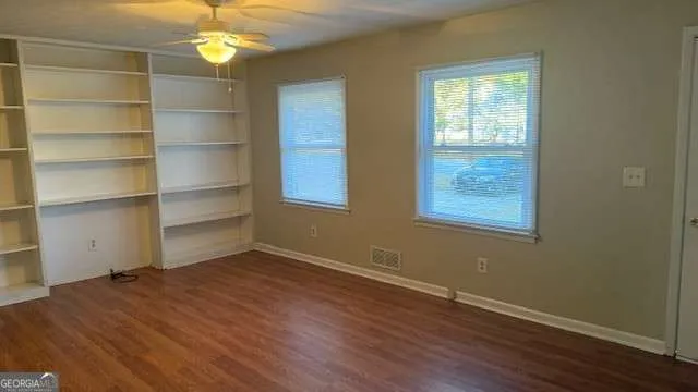 a view of a room with wooden floor and a window
