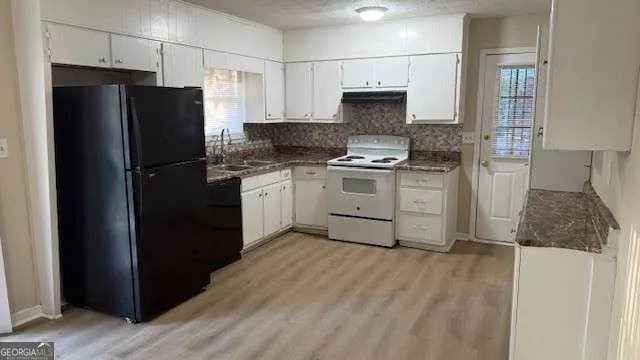 a kitchen with a refrigerator stove and sink