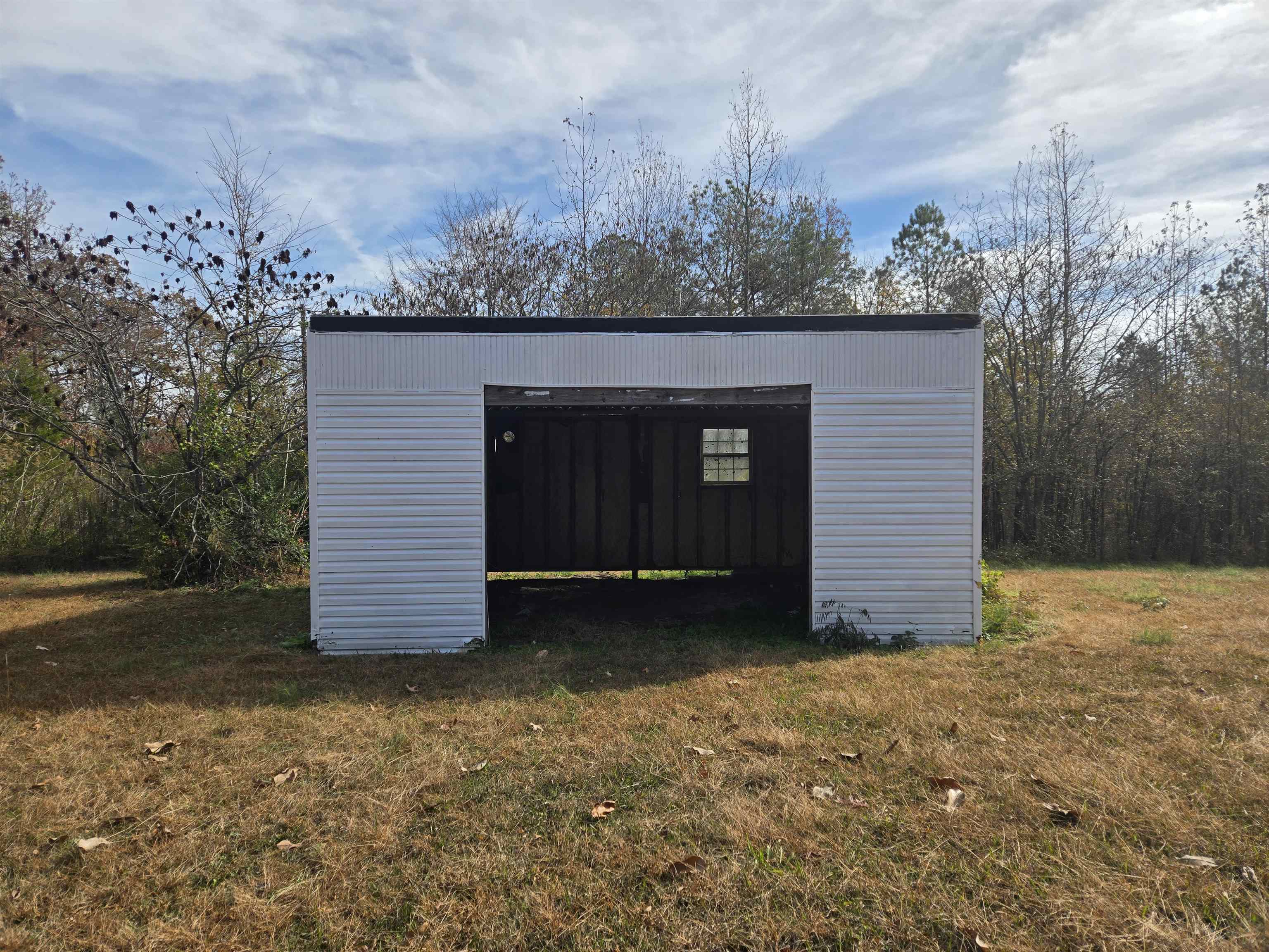 1907 Elmer Cox Road Bethel Springs, TN 38315 - Photo 16 of 17 a view of a wooden house with a yard