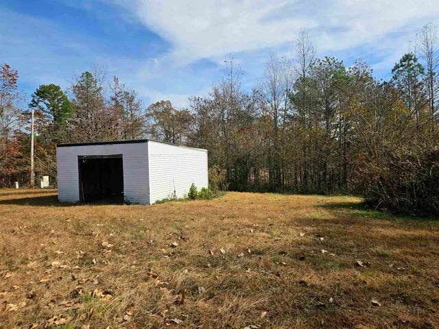 a backyard of a house with large trees