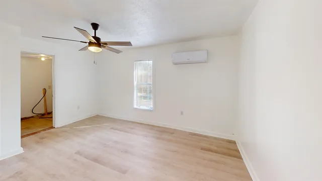 a view of a room with a ceiling fan and a window