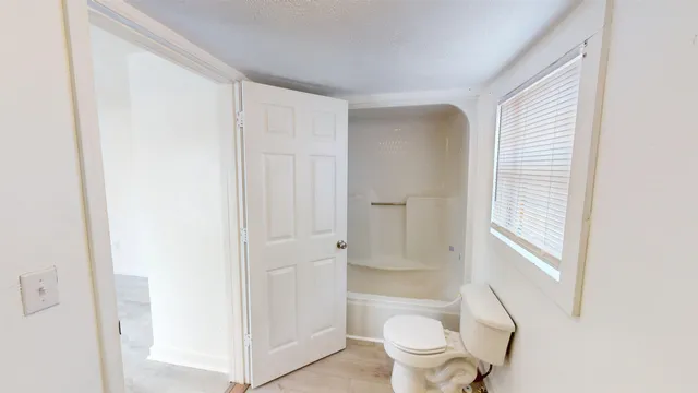 a white toilet sitting next to a bathroom sink