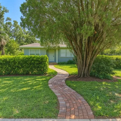 a view of a backyard with a garden and trees