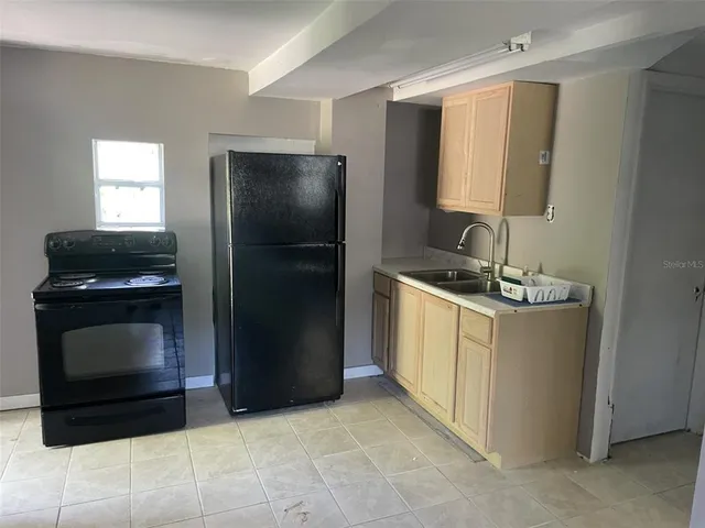 a kitchen with a refrigerator stove and microwave