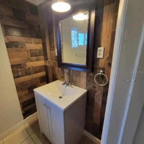 a bathroom with a sink a toilet and mirror