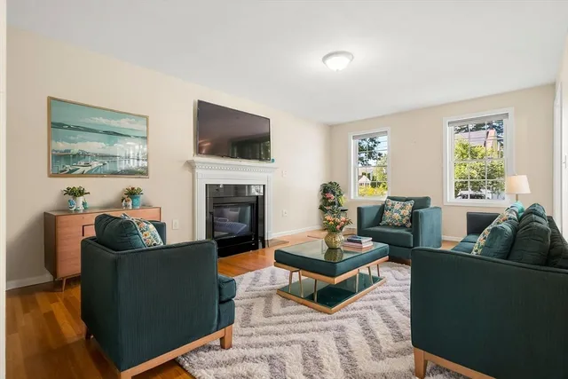 a living room with furniture a flat screen tv and a fireplace