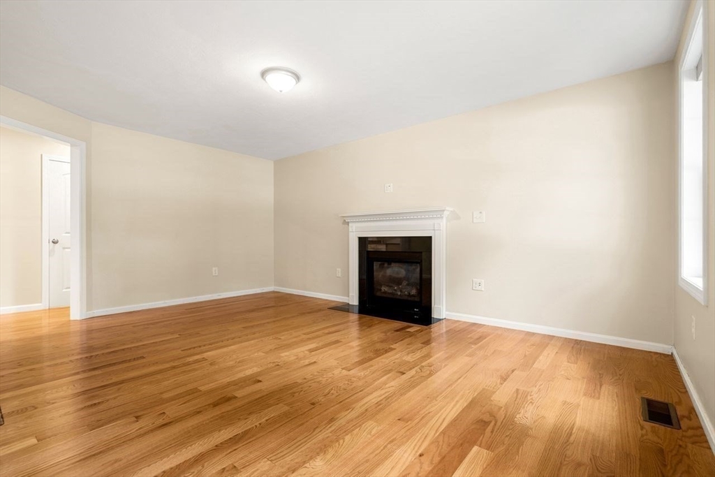 79 Bridle Road Billerica, MA 01821 - Photo 14 of 42 a view of empty room with wooden floor and fireplace