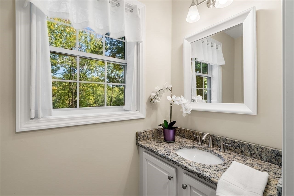 79 Bridle Road Billerica, MA 01821 - Photo 16 of 42 a bathroom with a granite countertop sink and a window