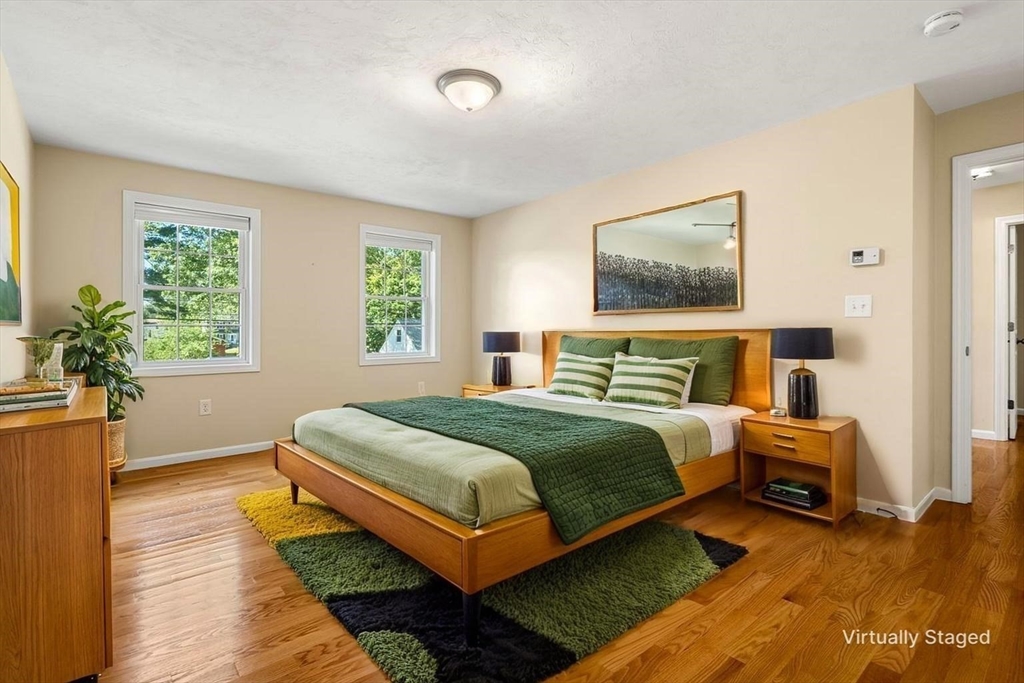 79 Bridle Road Billerica, MA 01821 - Photo 23 of 42 a bedroom with a bed lamp and a potted plant