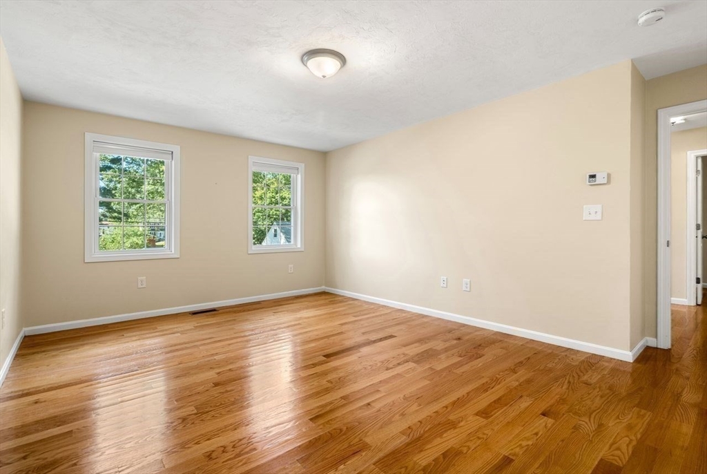 79 Bridle Road Billerica, MA 01821 - Photo 24 of 42 an empty room with wooden floor and windows