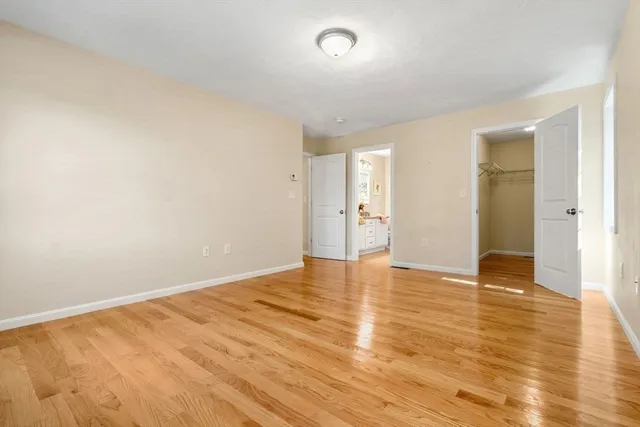 a view of an empty room and wooden floor