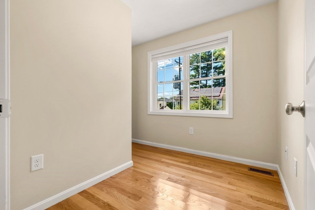 79 Bridle Road Billerica, MA 01821 - Photo 29 of 42 a view of an empty room with wooden floor and a window