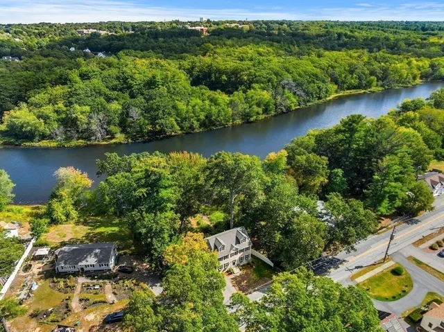 an aerial view of a house with a yard lake view and mountain view