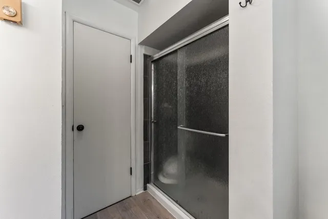 a bathroom with a glass shower door