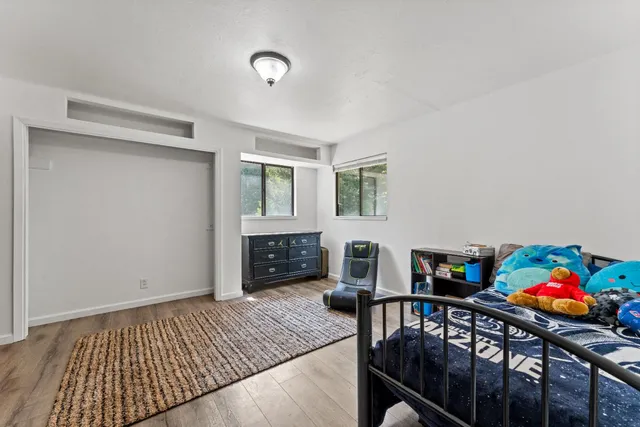 a bedroom with furniture and a window