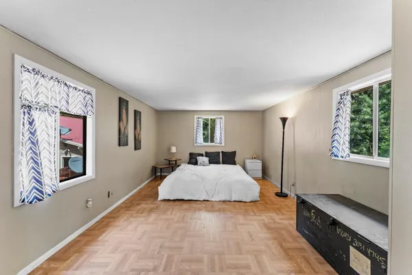 a bed room with a bed and a window
