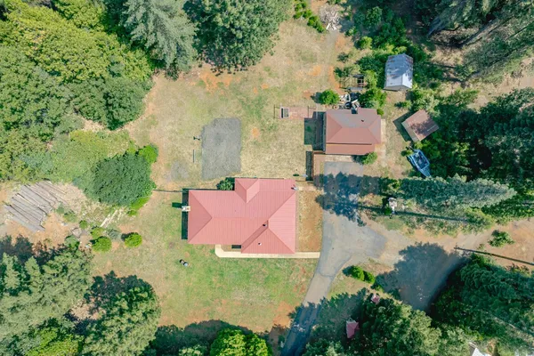 an aerial view of a house with outdoor space