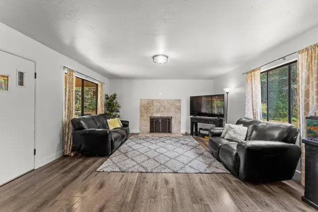 a living room with furniture fireplace and flat screen tv
