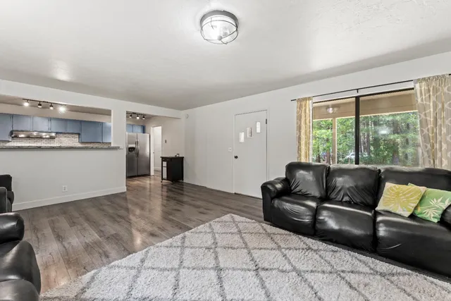 a living room with furniture and a floor to ceiling window