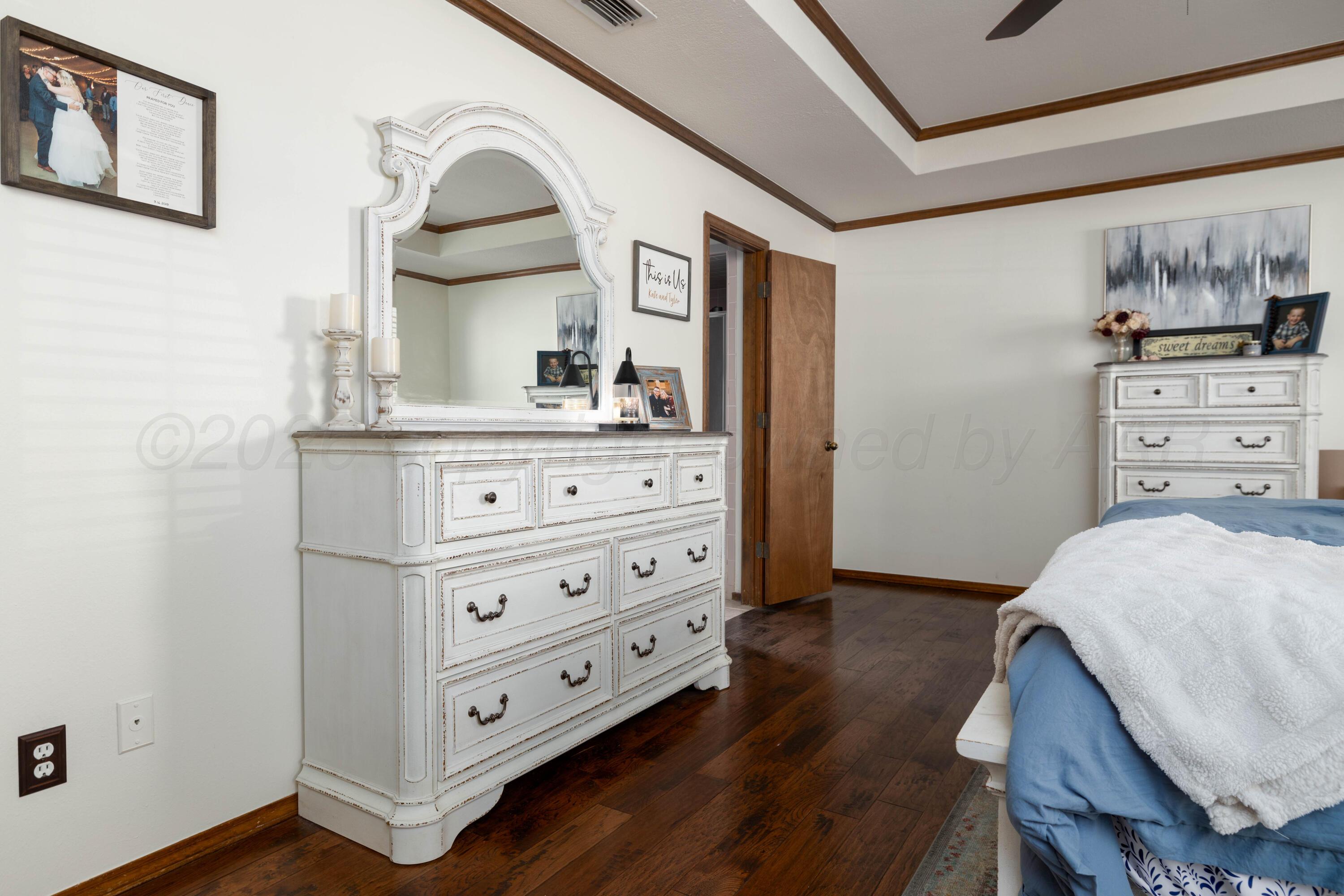 6801 Rochelle Lane Amarillo, TX 79109 - Photo 17 of 40 a bedroom with a bed and a dresser