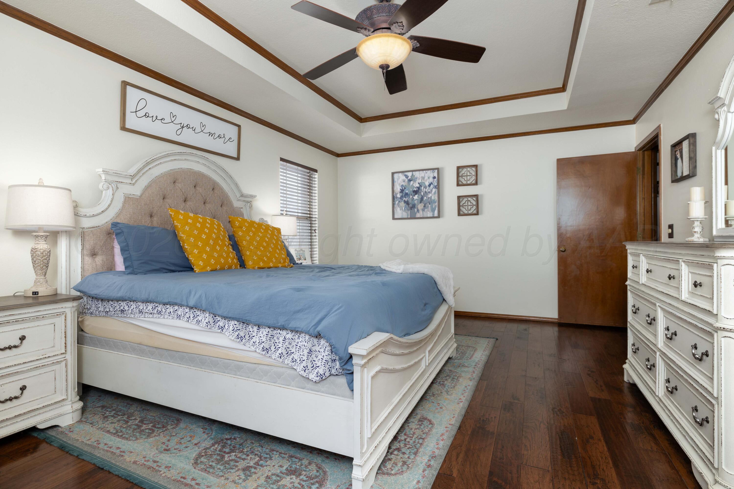 6801 Rochelle Lane Amarillo, TX 79109 - Photo 18 of 40 a bedroom with a bed dresser and a window
