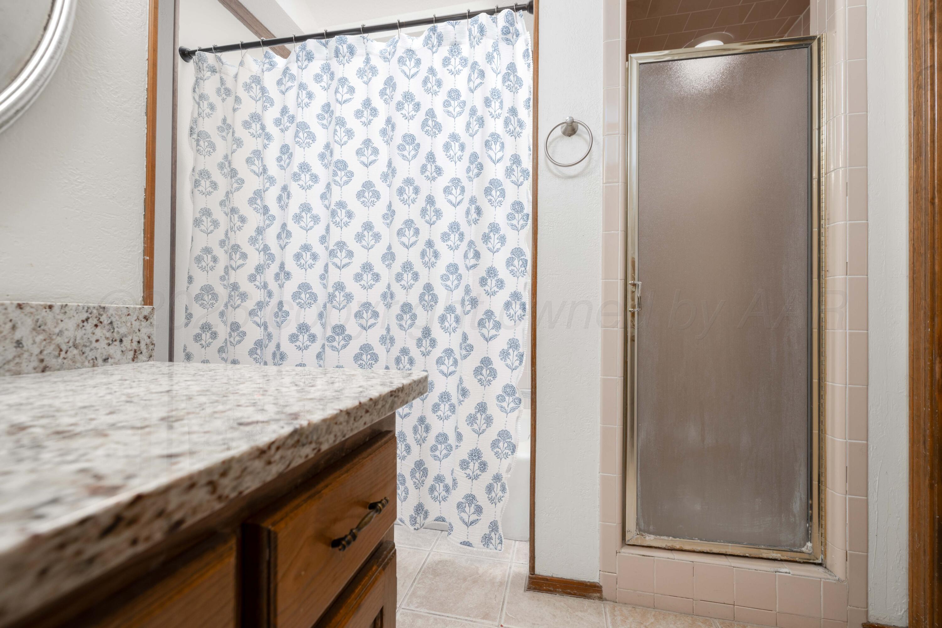 6801 Rochelle Lane Amarillo, TX 79109 - Photo 21 of 40 a bathroom with a granite countertop sink and a mirror