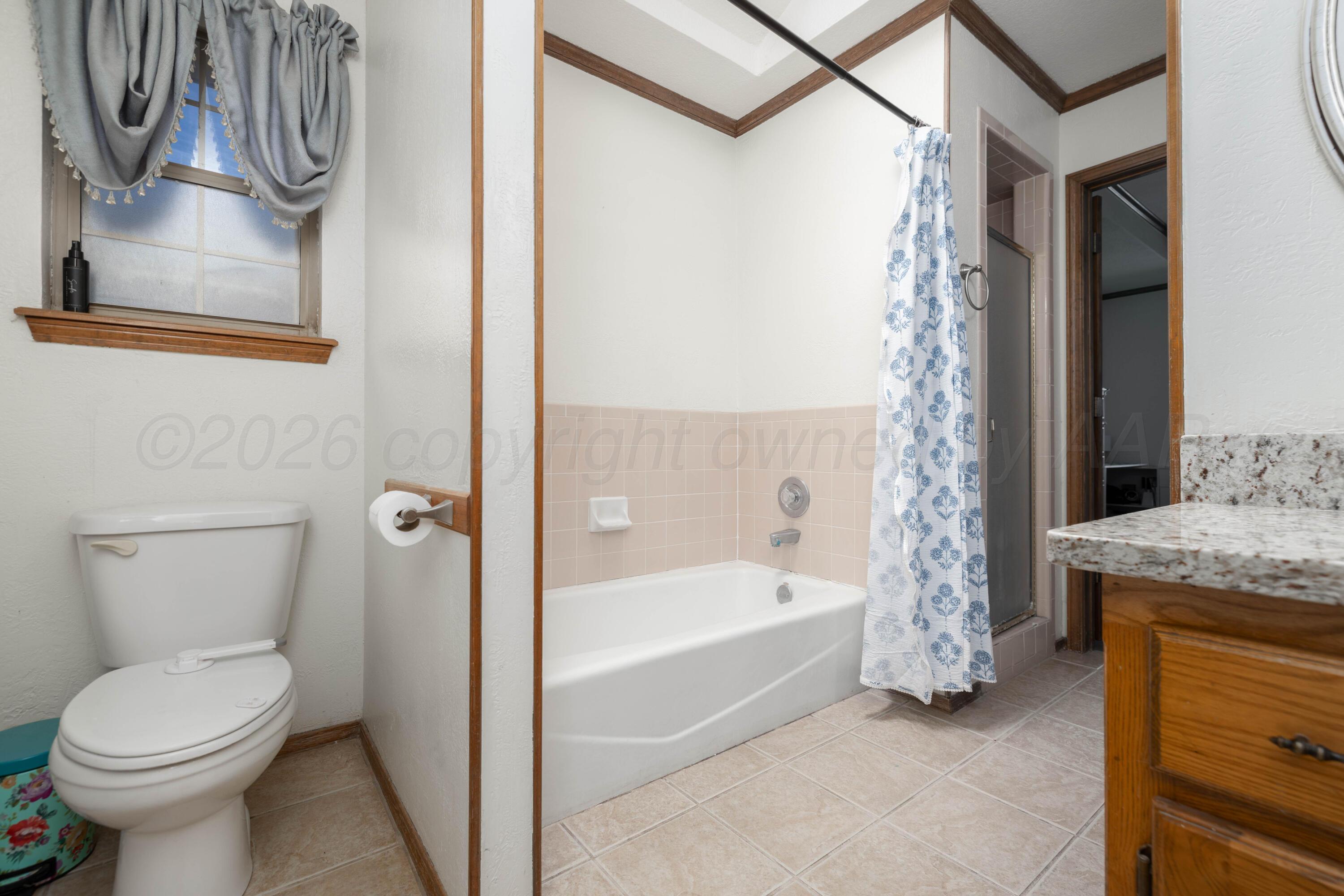 6801 Rochelle Lane Amarillo, TX 79109 - Photo 23 of 40 a bathroom with a sink a toilet and a bathtub