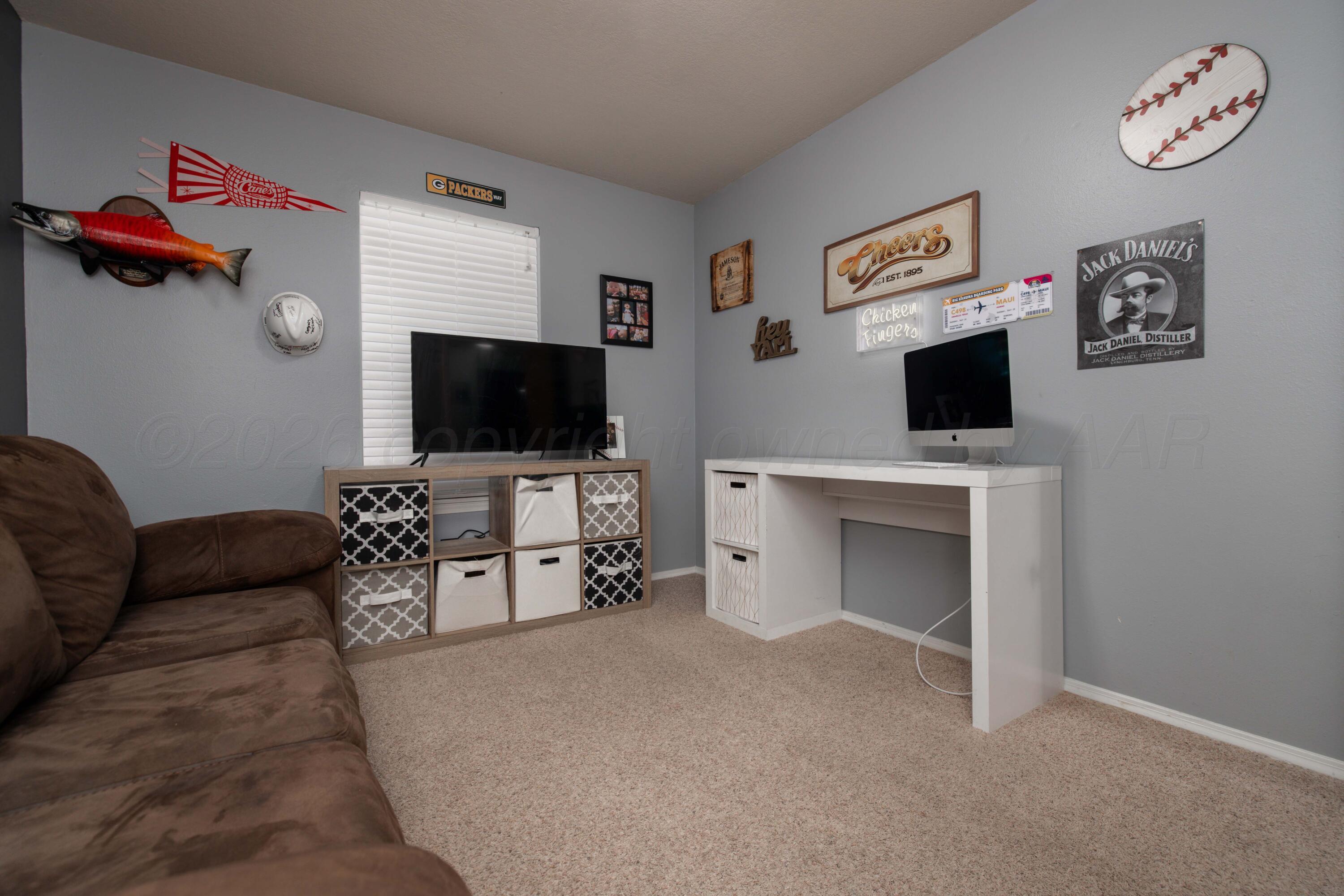 6801 Rochelle Lane Amarillo, TX 79109 - Photo 26 of 40 a living room with furniture and a flat screen tv
