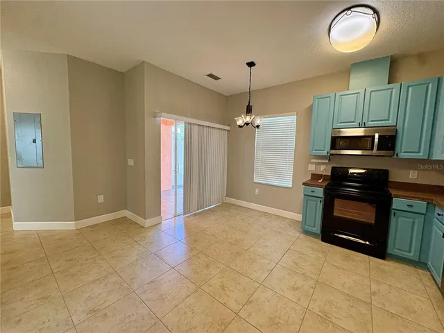 a view of a kitchen with a stove cabinets and entryway