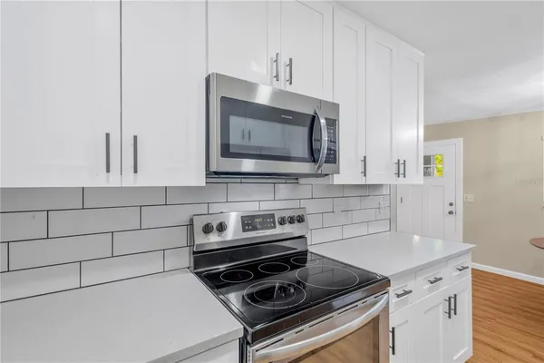 a kitchen with a stove and a microwave